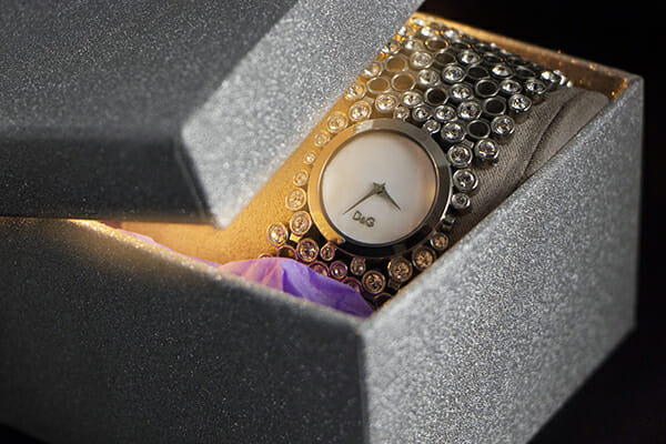 a part opened box with a silver watch inside
