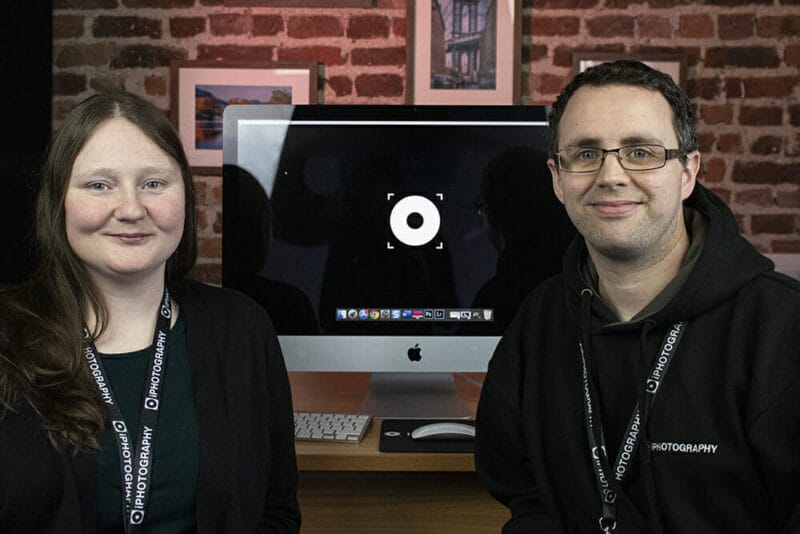Emily Lowrey and Stephen Walton, photographers sat in front of a mac computer