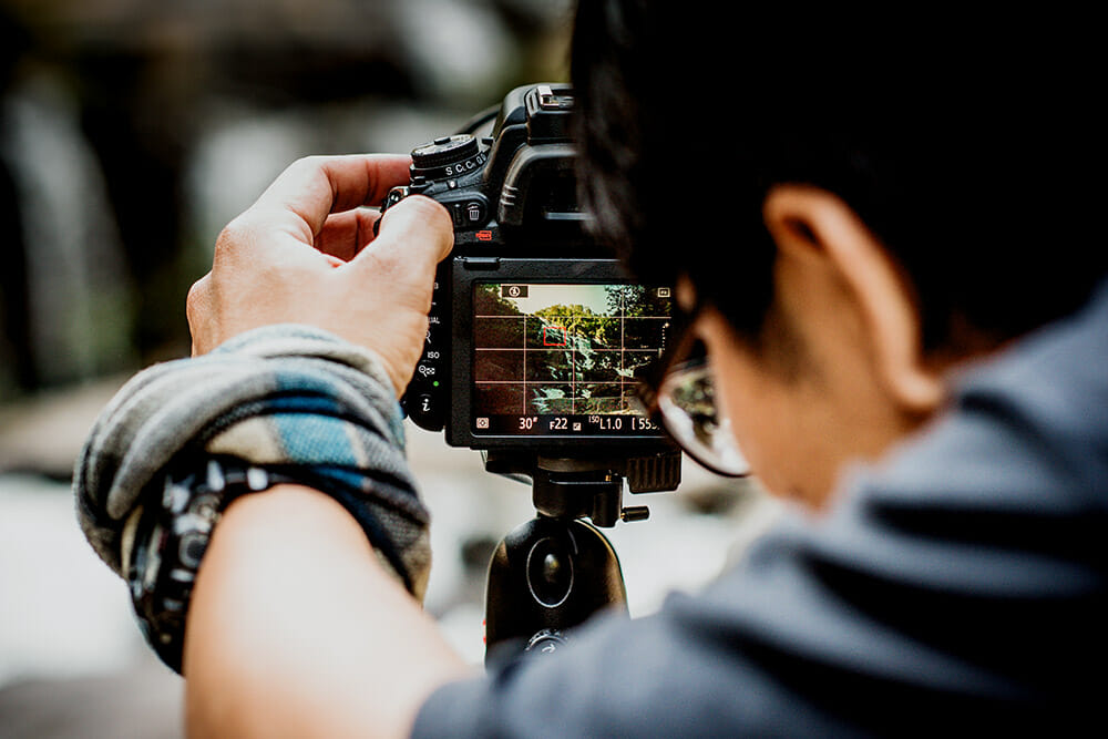 Nature Photography TIps man behind a camera screen