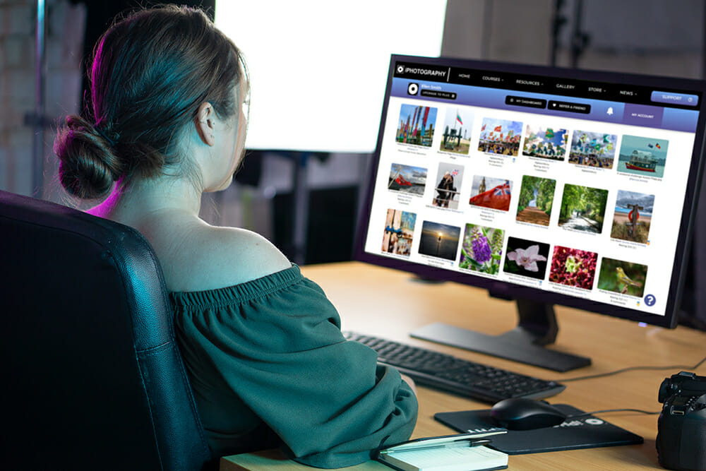 Woman sat at a computer learning photography
