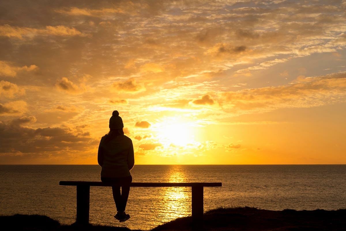 Wide,Angle,Shot,Of,The,Silhouette,Of,A,Woman,Sitting