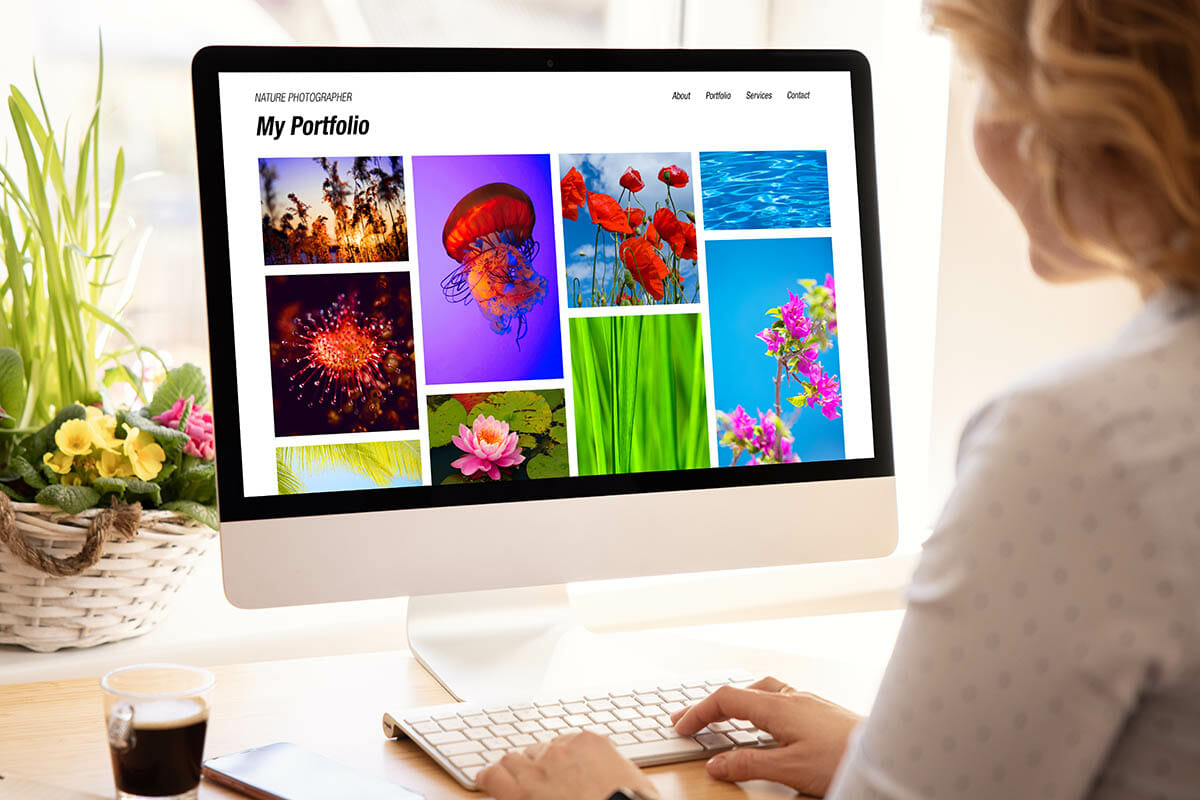 Woman viewing photography portfolio website on computer screen