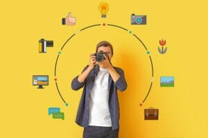 Young man with camera on color background. Mentoring for photographers