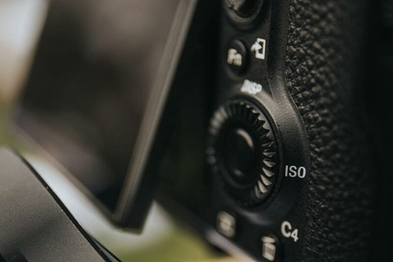 A selective focus shot of iso button of a digital camera with flip screen