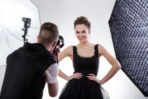 Fashion photographer and model working together, horizontal