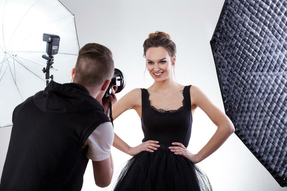 Fashion photographer and model working together, horizontal