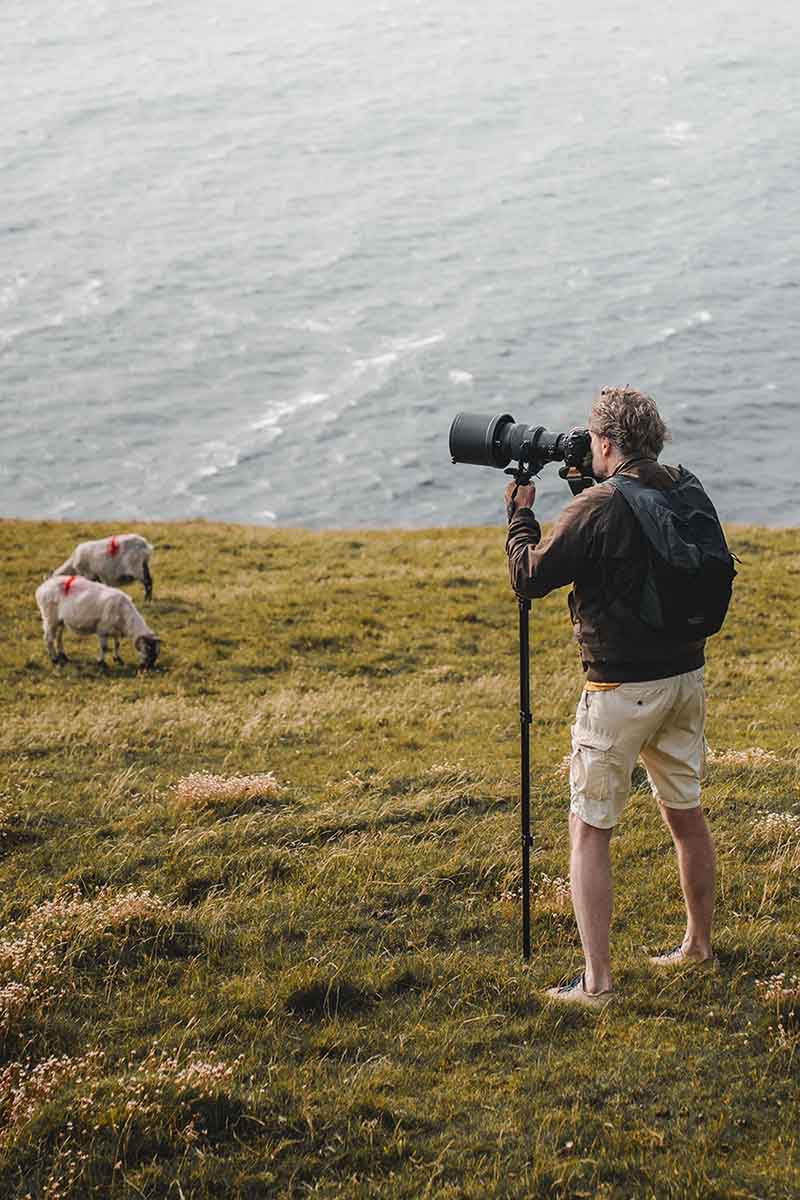 man taking photos with a monopod