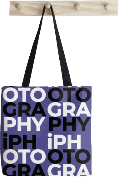 An iPhotography tote bag printed with the wordmark scattered in blue, black and white blocks.
